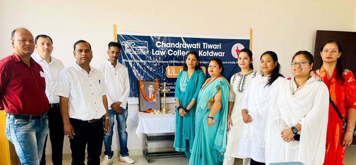 Students standing and saluting the picture of Dr. Bhimrao Ambedkar during the birth anniversary celebration at Chandrawati Tiwari Law College.